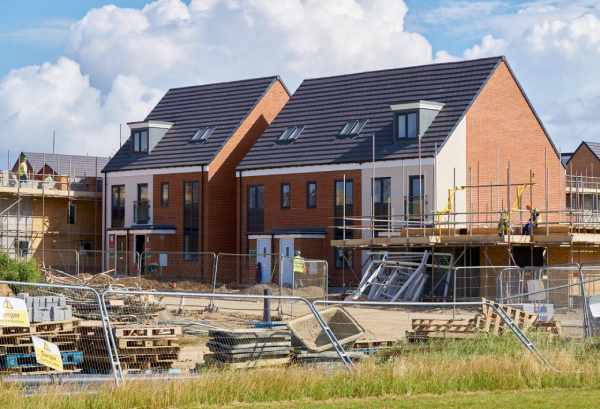 New build properties undergoing construction, pictured on a sunny day