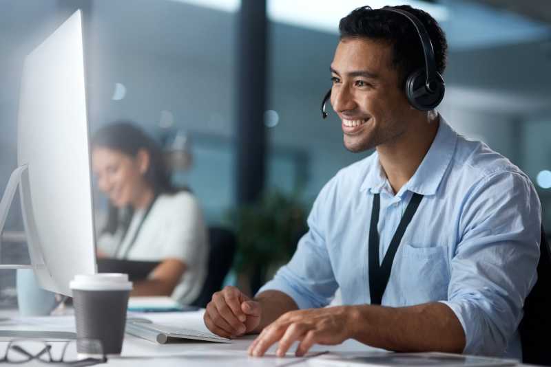 A smiling solicitor speaks to a client over the phone