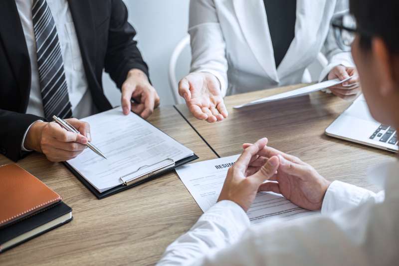 A solicitor covers funding options with his client during a consultation