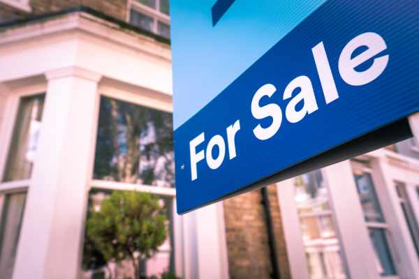 A "for sale" sign displayed on the front of a leasehold property