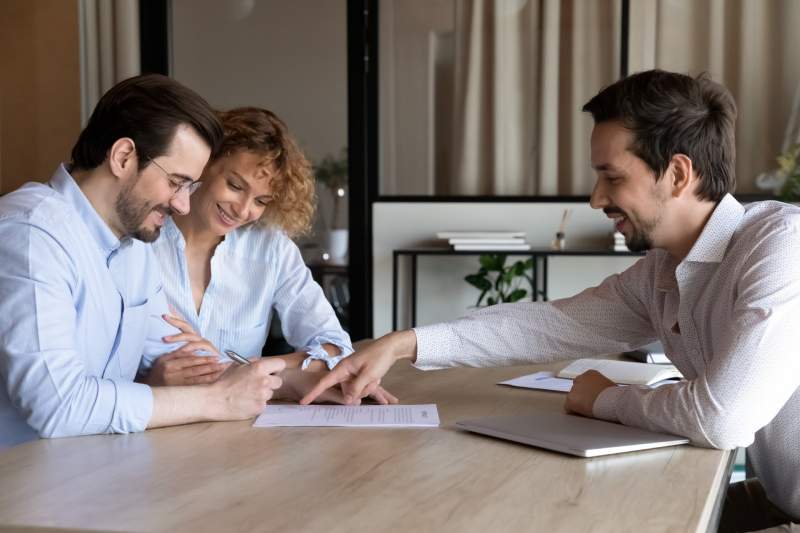 A solicitor gives legal advice to his clients during a consultation