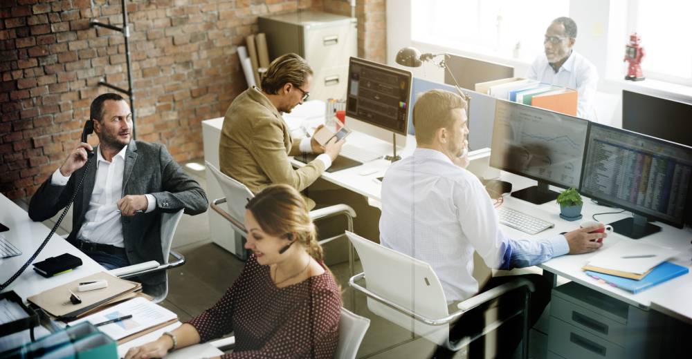 A busy office with solicitors working at their desks